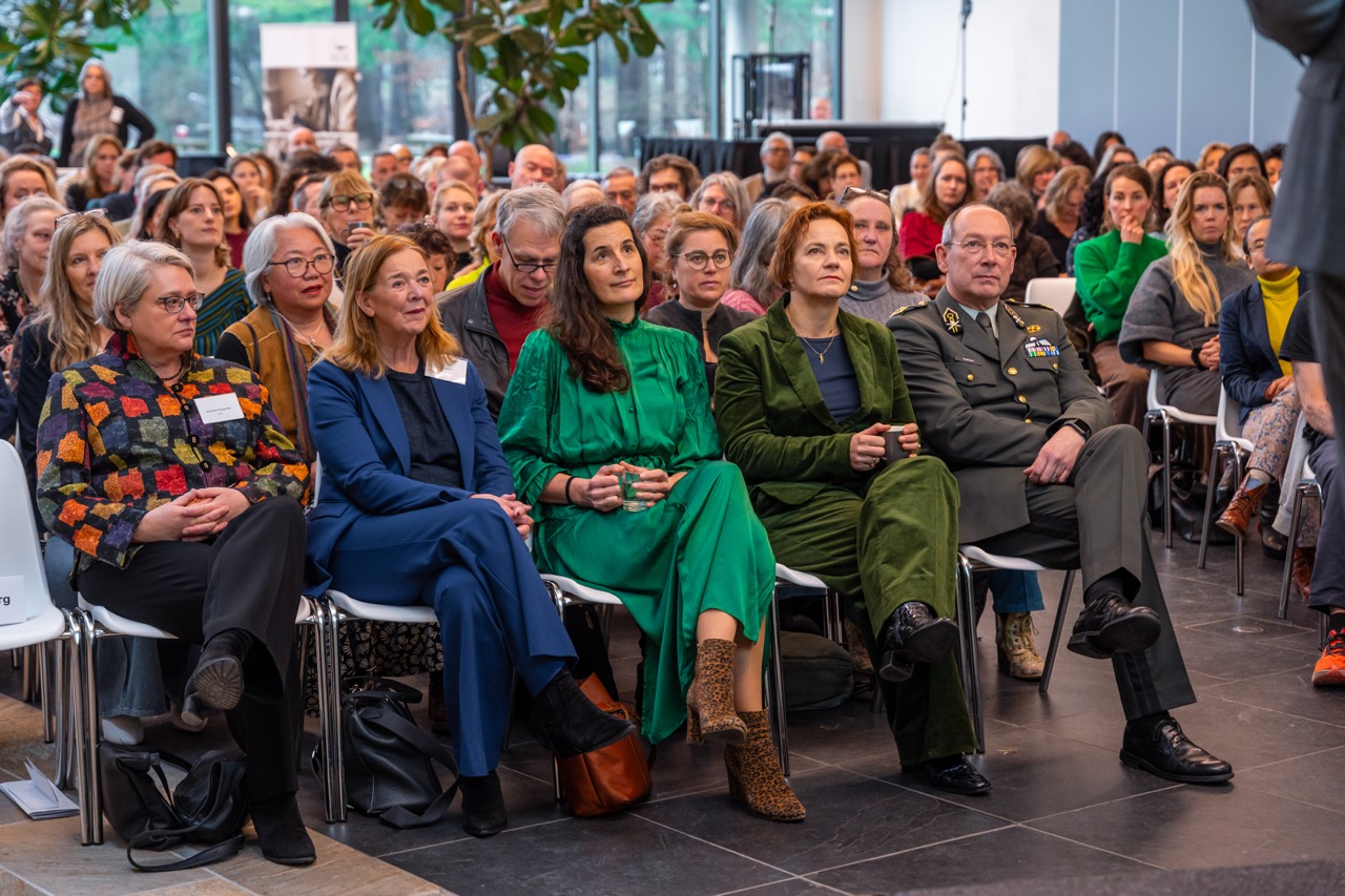 A seated audience at an indoor event