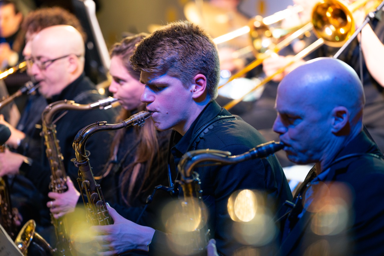 Saxophone section of a big band mid-performance